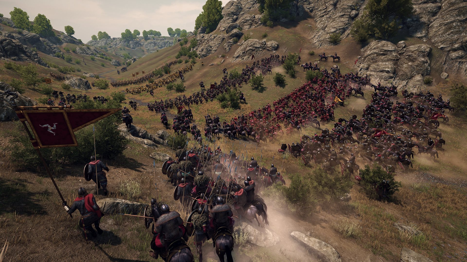 Horsemen charging down a rocky valley under a triskelion banner