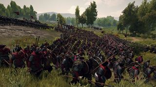 Red-cloaked infantry pushing up through the long grass, shields and spears ready