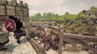 On the castle wall, looking down on the assault at its foot