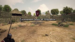 A tournament bout at Hólmatún in Mön — the host's arms over the bout's title, its standards round the ring and the stands full